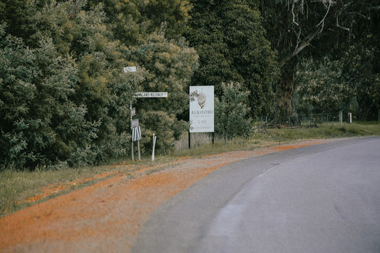 A curved road with a sign on the side of it