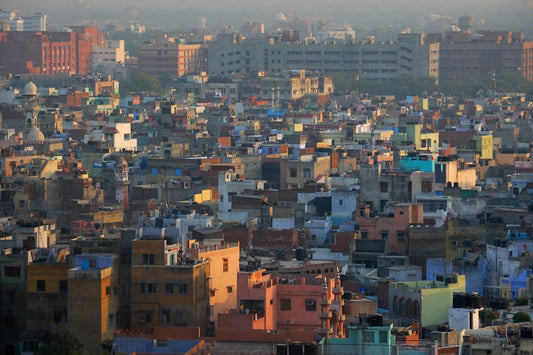 Cityscape with colorful buildings and hazy sky.