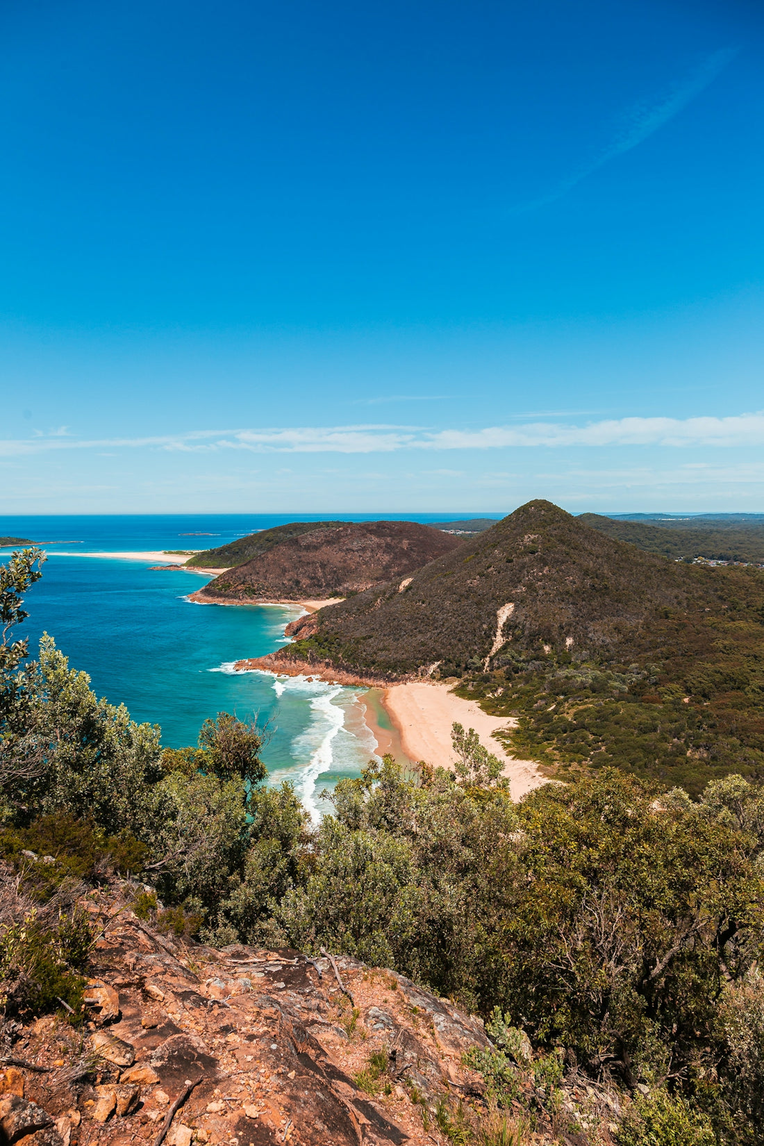 Beautiful beach with clear blue water and sky.