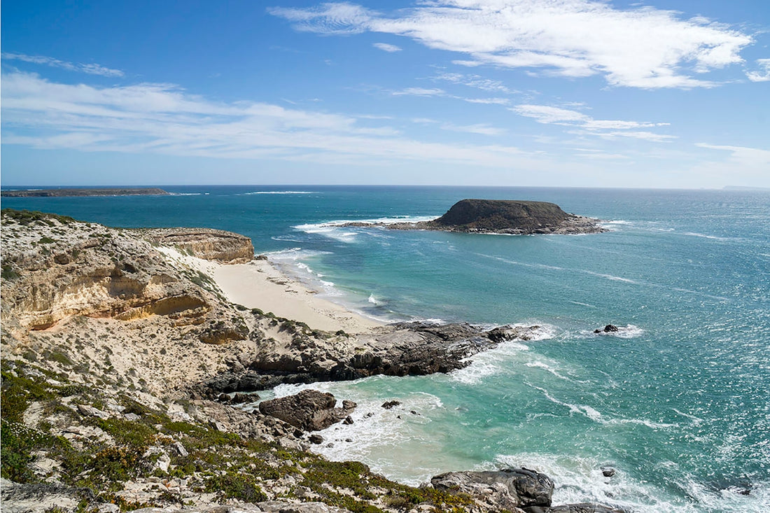 Rocky coastline with sandy beach and ocean waves
