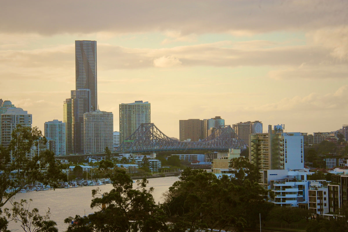 City skyline with river and bridge at sunset
