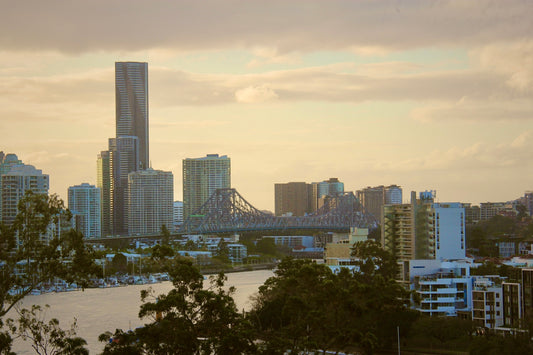 City skyline with river and bridge at sunset