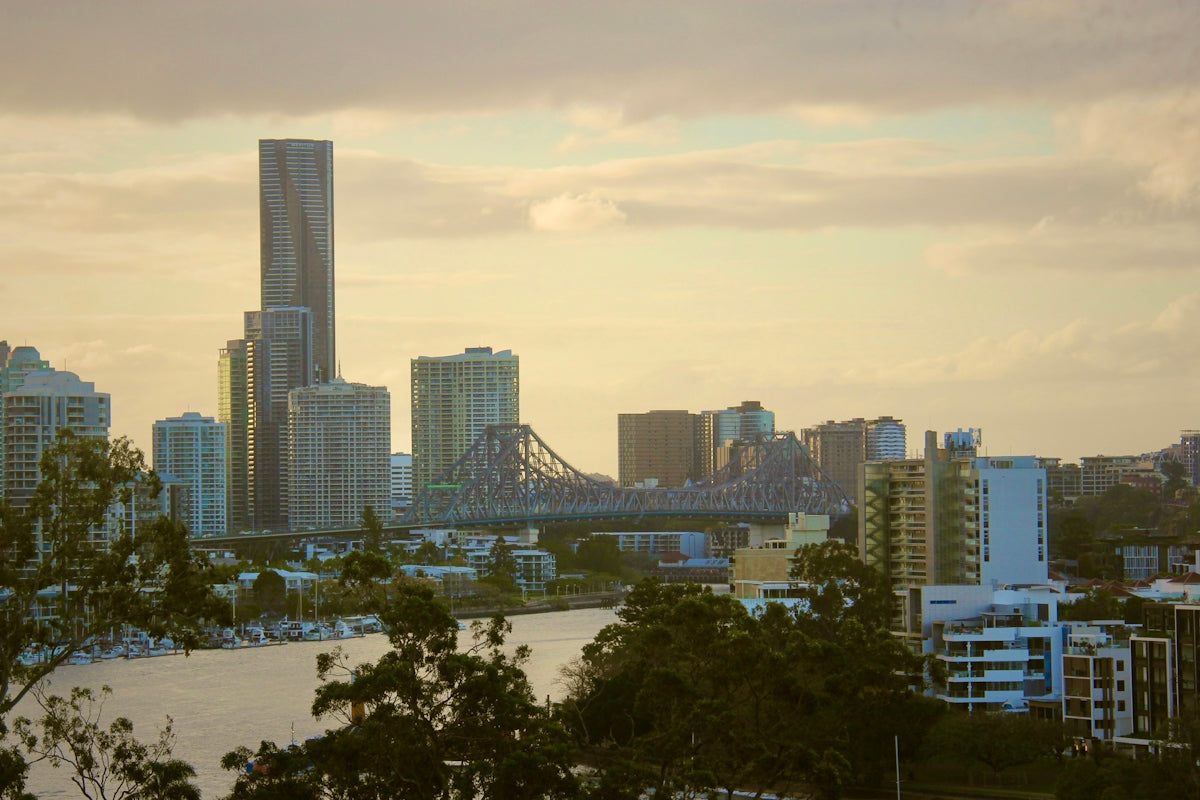 City skyline with river and bridge at sunset