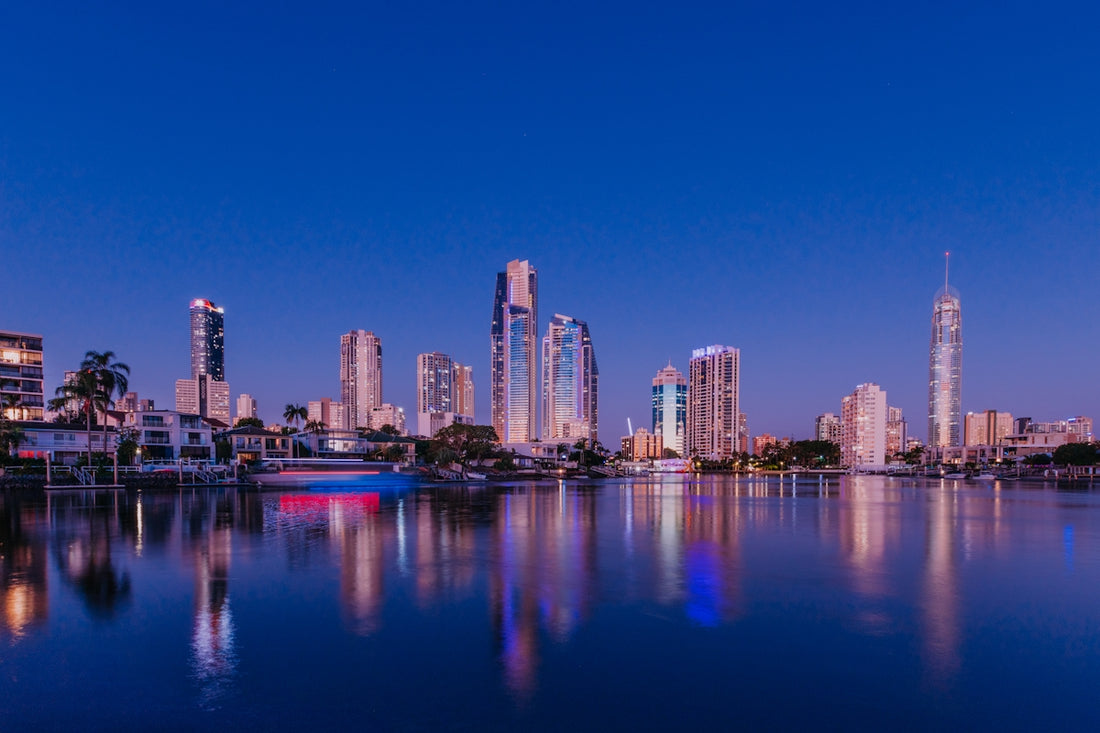 City skyline reflected in calm water at dusk