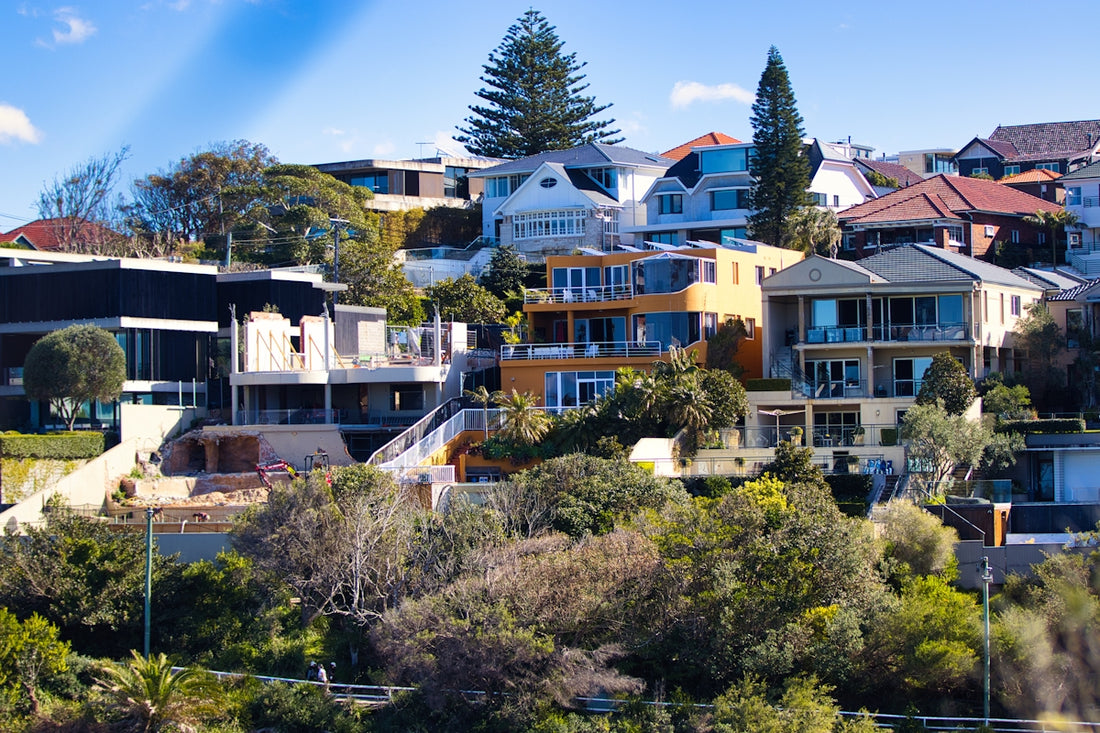 Modern houses on a lush, green hillside.
