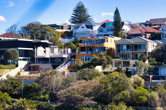 Modern houses on a lush, green hillside.