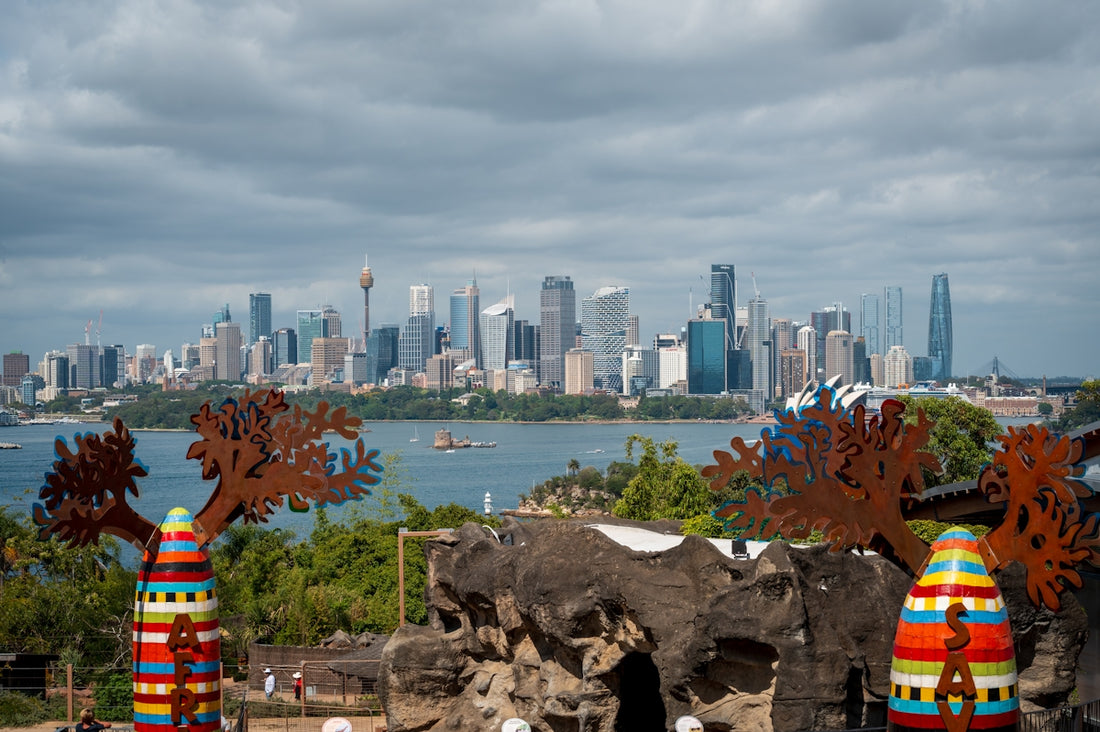 City skyline across a bay with decorative sculptures