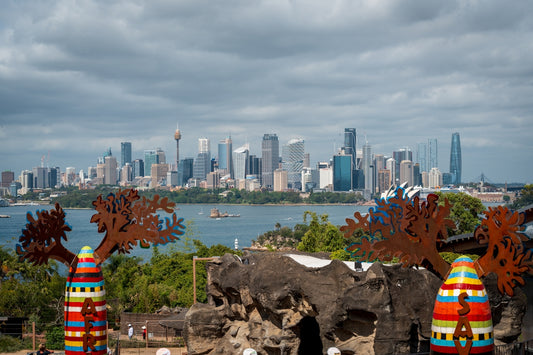 City skyline across a bay with decorative sculptures