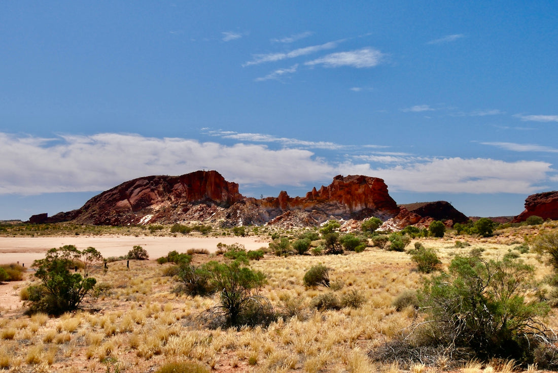 Dry australian outback landscape with rock formations and sparse vegetation