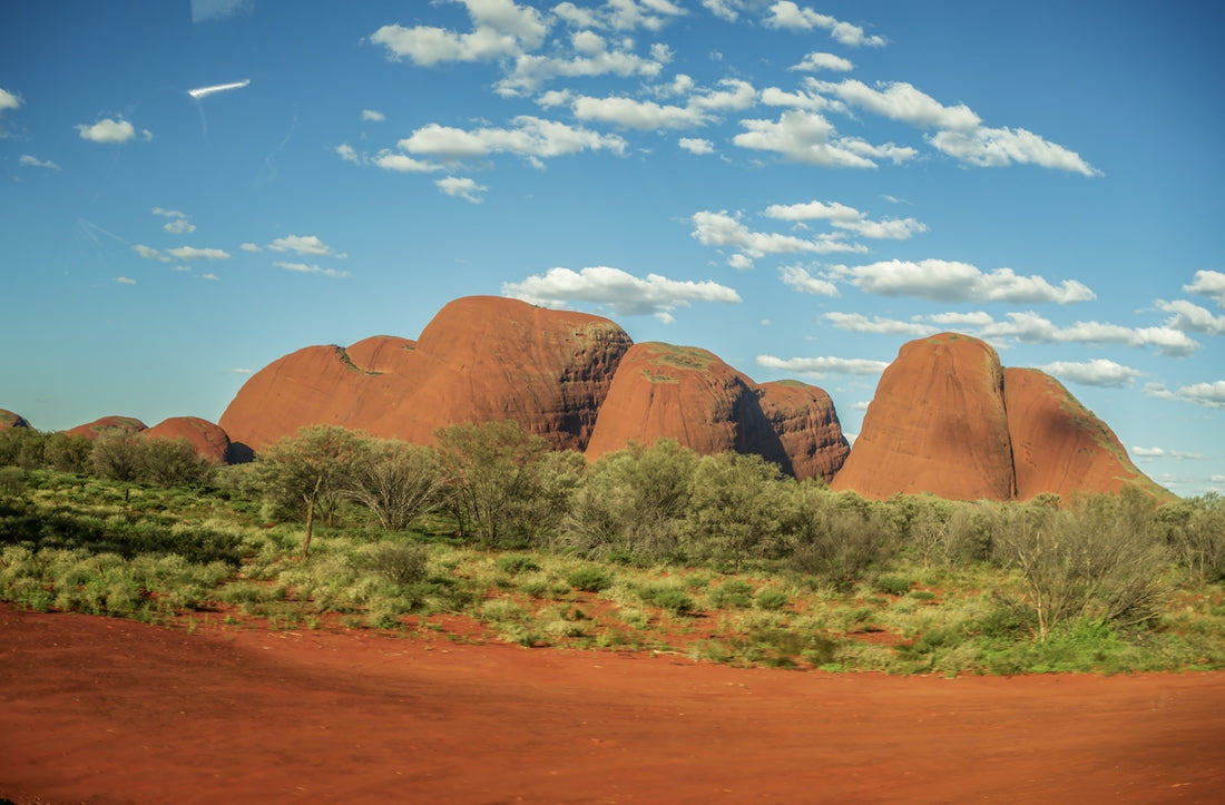 Red rock formations and desert landscape under a blue sky.