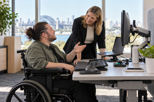 Employee with disability discussing ergonomic workstation adjustments and assistive technology with a manager